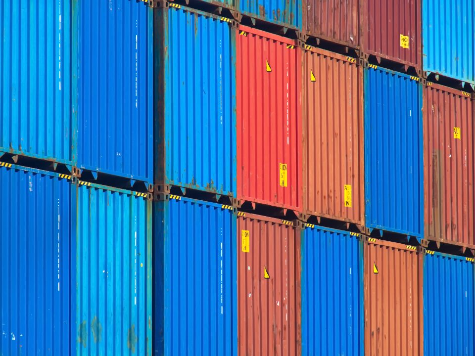 Colourful shipping containers stacked on top of each other