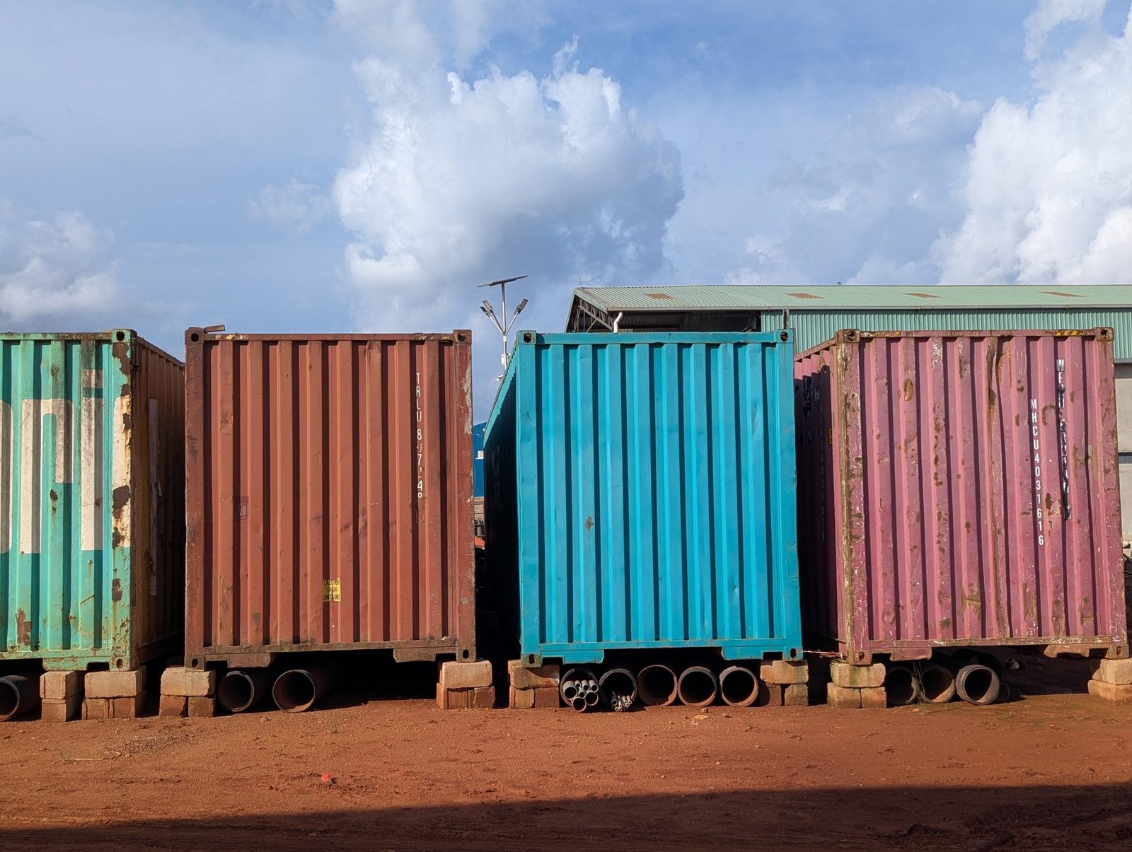 Shipping containers standing under a blue sky